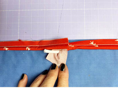 remove the stitch of the piping on one end and expose the cord
